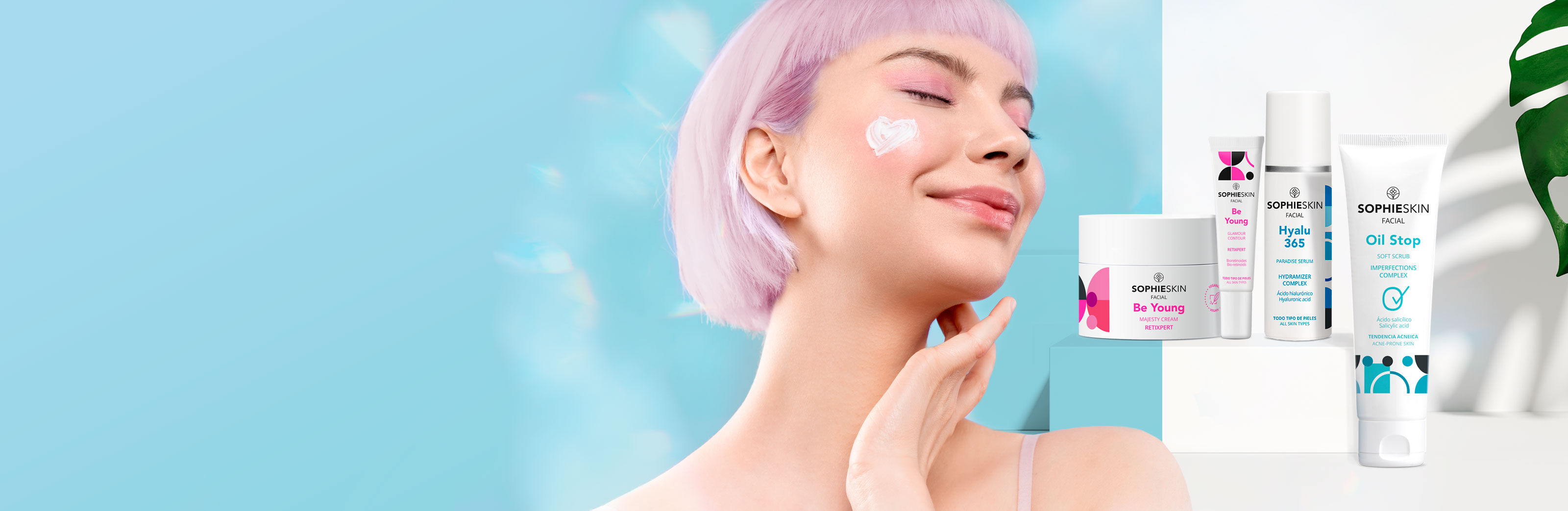 Imagen chica con pelo rosa sonriendo, ojos cerrados y crema en el p&oacute;mulo, al lado cuatro productos Sophieskin